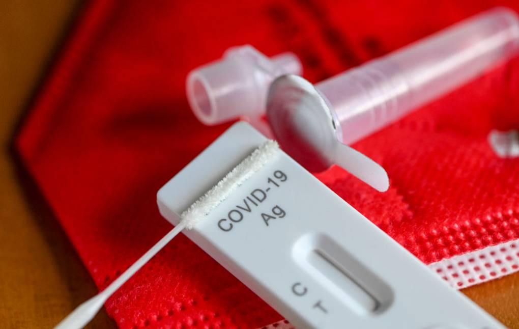 An antigen test to detect COVID-19 for self-testing is on a red FFP-2 mask.